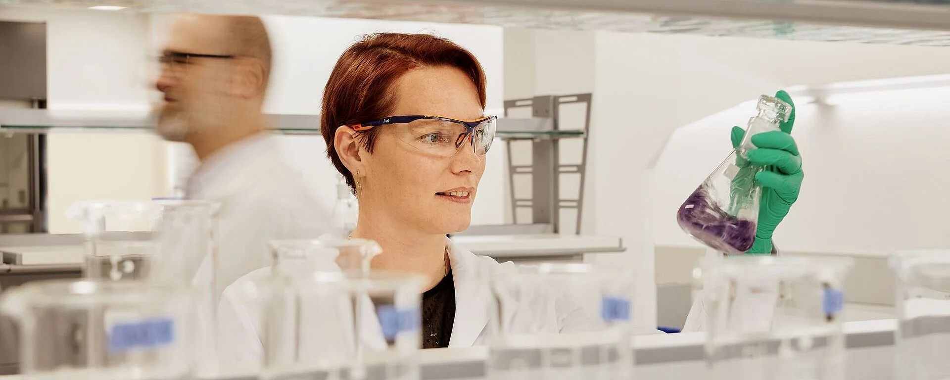 Scientist in a laboratory holding a laboratory flask