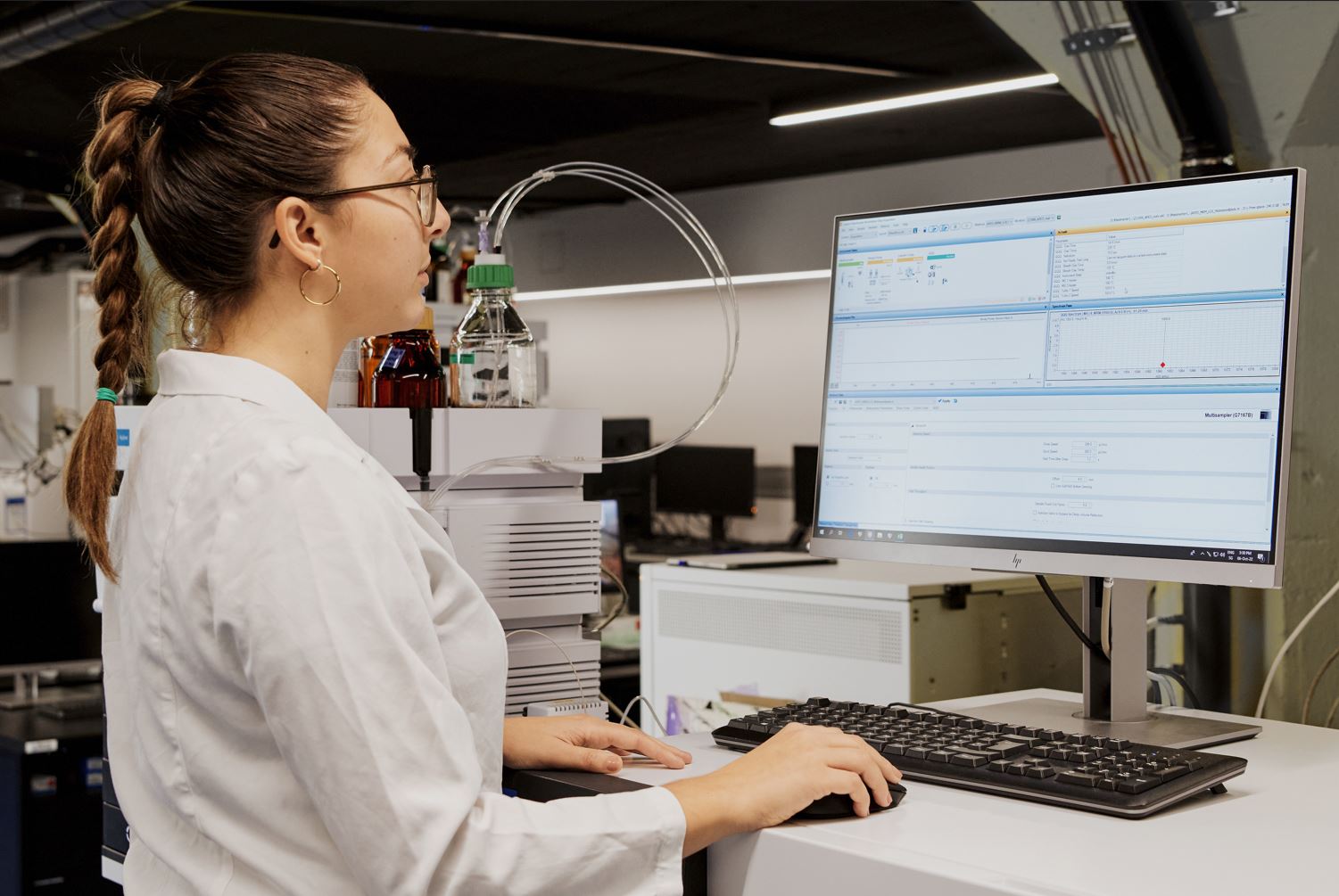 Laboratory assistant controlling test results on computer